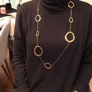 Modern gold tone accent necklace.